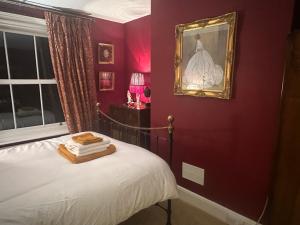 a bedroom with a bed with a picture on the wall at Hitchcock House in Hastings