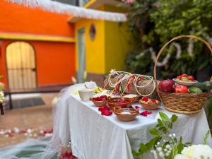 a table with bowls of fruit and baskets on it at Posada Temazcal Santo Domingo in Tepoztlán