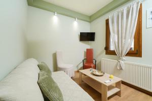 a living room with a couch and a table at Christina's Village Home in Kallirakhi