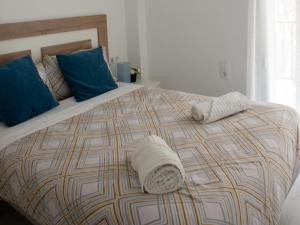 a large bed with two pillows on top of it at Wonderful apartment in Gavà. Barcelona in Gavà