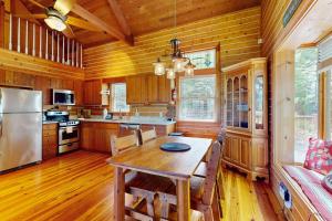 Una cocina con una mesa de madera y un refrigerador. en Down by the River, en Blue Ridge