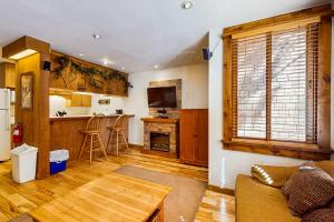 a kitchen and living room with a couch and a table at Cozy Condo in Ski Trails in Truckee