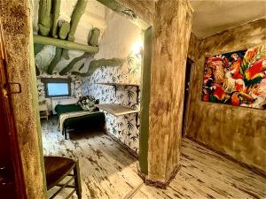 a hallway of a room with a painting on the wall at Riojania La Posada in Santa Eulalia Bajera