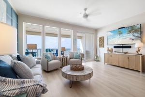 una sala de estar con un sofá y una mesa en Sea Glass 402 by Liquid Life, en Gulf Shores