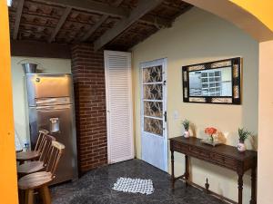 a kitchen with a refrigerator and a table and chairs at Recanto Paraíso in Cotia