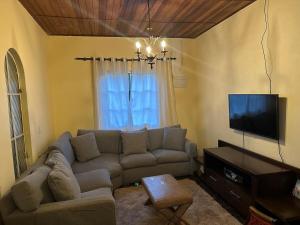 a living room with a couch and a flat screen tv at Recanto Paraíso in Cotia