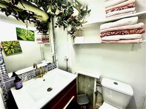 a bathroom with a sink and a toilet and a mirror at Riojania La Posada in Santa Eulalia Bajera