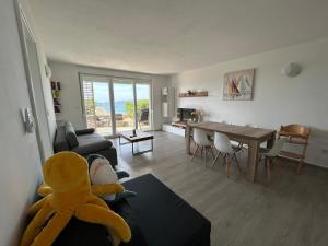 a living room with a stuffed animal sitting on a couch at Blauer Horizont in Povljana