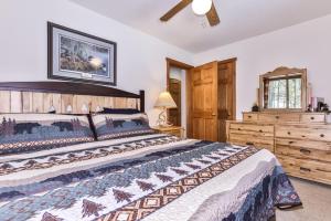 een slaapkamer met een groot bed en een ladekast bij Tall Pines Lodge in Eagle River WI in Eagle River