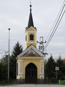 a small church with a steeple on top of it at Atera in Banovci