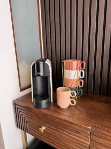 a coffee maker and a blender on a wooden table at Chilometro Mille Suites e Apartments in Otranto