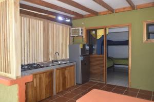 a kitchen with a sink and a refrigerator at Playa Pavones Il Defino #1 in Pavones
