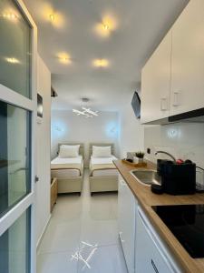 a kitchen with white cabinets and a counter top at Armonia Studio in Pefkohori