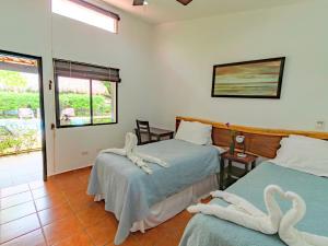 two beds in a room with swans on the beds at Hotel Ingigante in Rivas +60 photos
