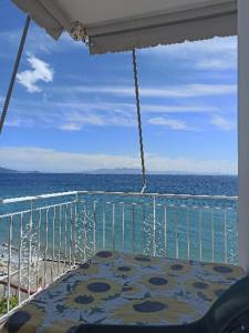 a balcony with a view of the beach and the ocean at Sunset Boulevard Rooms in Qeparo +4 photos