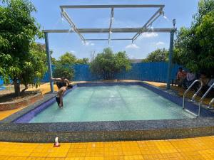 a man is on a pool of water at Raigad Agro Park in Mahād