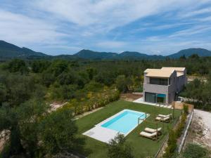 an aerial view of a house with a swimming pool at Olive Trees Villas in Episkopianá