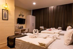 a hotel room with two beds with towels on them at Hotel Chandan Heritage in Bhubaneshwar +53 photos