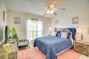 a bedroom with a blue bed and a ceiling fan at Private Pool and Park Access Cozy South Daytona Gem in South Daytona +22 photos