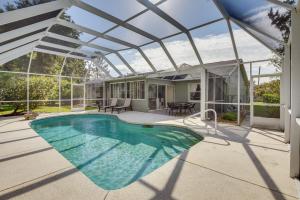 a swimming pool in a house with a glass roof at Private Pool and Park Access Cozy South Daytona Gem in South Daytona