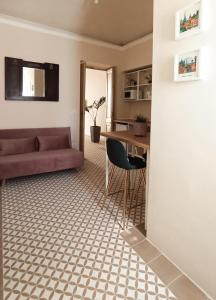 a living room with a couch and a table at Brindisina Apartment in Turin