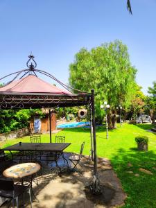 a picnic table and a gazebo in a park at Casale dei Villa villa with pool and private parking in Ciampino