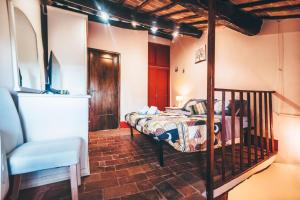 a bedroom with a bed and a chair at *La Torre Di Amelia* Nel Cuore Dell' Umbria in Amelia