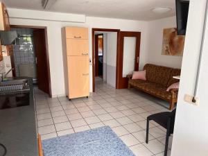 a living room with a couch and a table at Ferienwohnungen Im Hirschgrund in Frohnhausen +6 photos