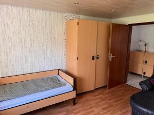 a small bedroom with a bed and a closet at Ferienwohnungen Im Hirschgrund in Frohnhausen