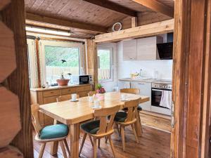 a kitchen with a wooden table and chairs in a cabin at Apartment Schachner-2 by Interhome in Saalbach Hinterglemm