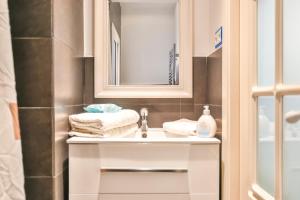 a bathroom with a sink and a mirror at Montroig Mar in Sitges +23 photos
