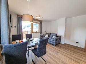 a living room with a table and a couch at Apartment Familienglück by Interhome in Oberau +44 photos