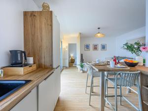 a kitchen and dining room with a table and chairs at Apartment Port Haliguen Plaisance-2 by Interhome in Quiberon