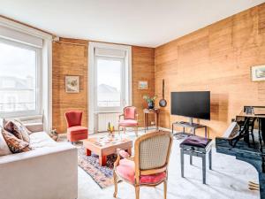 a living room with a couch and a tv at Apartment L'écluse-3 by Interhome in Dinard +20 photos