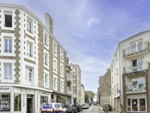 a city street with buildings and cars parked on the street at Apartment L'écluse-3 by Interhome in Dinard