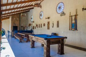 a room with two ping pong tables in it at Belíssima casa na praia do Morro Branco in Beberibe