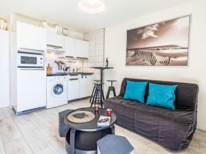 a living room with a couch and a kitchen at Apartment Maïtena by Interhome in Bidart +14 photos