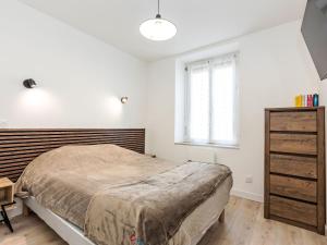 a bedroom with a large bed and a window at Holiday Home La main d'argent by Interhome in Saint-Méloir-des-Ondes