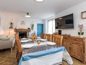 a dining room and living room with a table and chairs at Holiday Home La main d'argent by Interhome in Saint-Méloir-des-Ondes