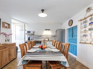 a dining room with a table and chairs at Holiday Home La main d'argent by Interhome in Saint-Méloir-des-Ondes +11 photos