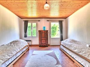a bedroom with two beds and a wooden ceiling at Holiday Home La Sablière by Interhome in Saint-Georges-dʼOléron