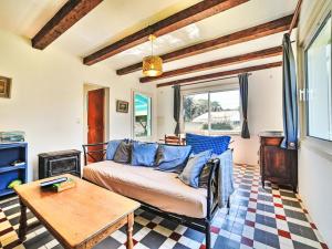 a living room with a couch and a table at Holiday Home La Sablière by Interhome in Saint-Georges-dʼOléron