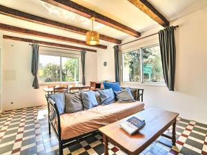 a living room with a couch and a table at Holiday Home La Sablière by Interhome in Saint-Georges-dʼOléron