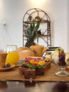 a table topped with food and a glass of orange juice at Posada ALAS FUENTES in San Fernando del Valle de Catamarca