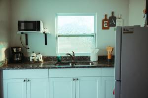 a kitchen with a sink and a microwave at VillaBella in Fort Myers