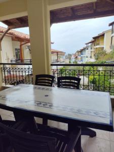 a table and chairs on a balcony with a view at Siviri Blue Horizon Apartment in Siviri +15 photos