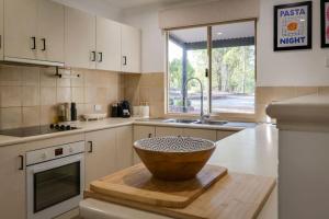 a kitchen with a bowl on a wooden cutting board at Karla Kuliny - A Peaceful Escape in Quindalup