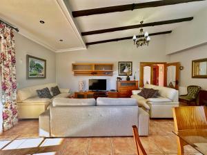 a living room with two couches and a tv at Villa Josefi en Isla 5816 in Isla