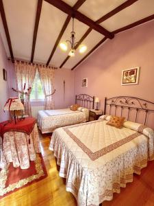 a large bedroom with two beds and a table at Villa Josefi en Isla 5816 in Isla