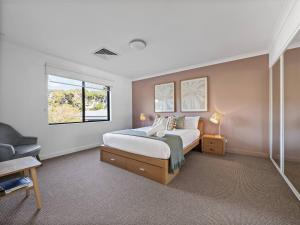 a bedroom with a bed and a window at Seventh Heaven Surfside in Yallingup